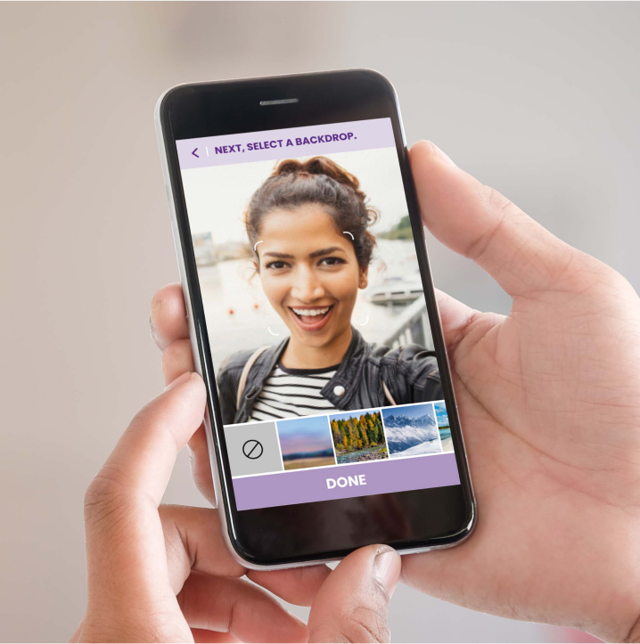 A person holding a cell phone with the Systane Selfie App opened.