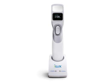 Systane iLux device sitting on the charging station
