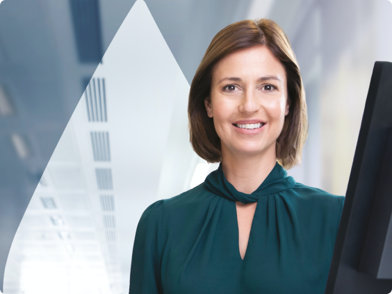 Stylized Image of a woman in a green shirt at a desktop computer.