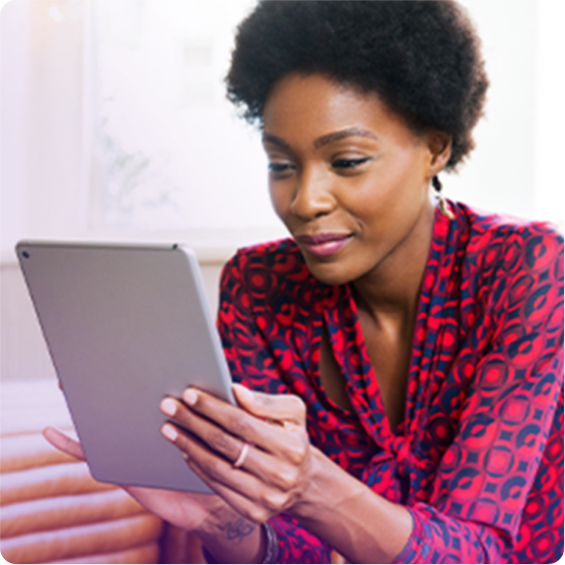 Woman working in a coffee shop with an ipad.