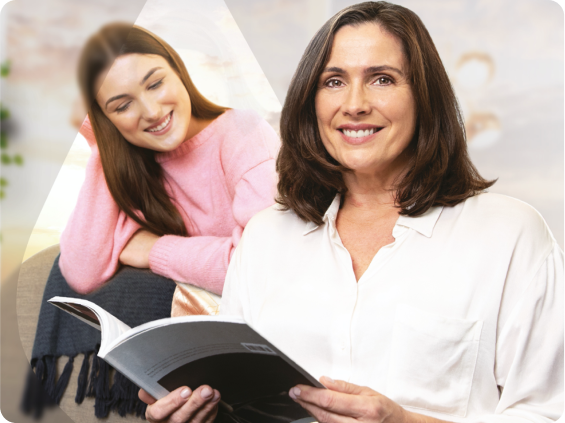 A woman reading a pamphlet with her college aged daughter.