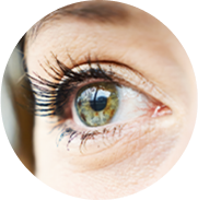 Closeup shot of a green eye experiencing dry eye, looking to the distance