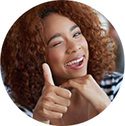 Young woman winking and giving a thumbs up