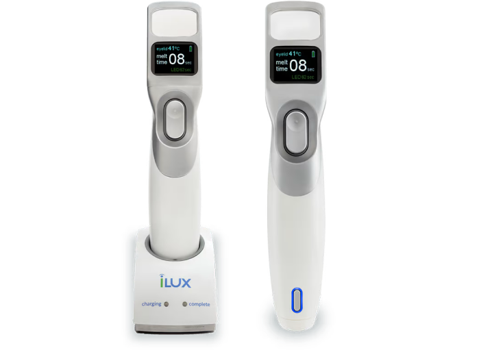 Two iLUX devices are shown side by side. The device on the left is placed on a charging station labeled with the iLUX logo and indicators for 'charging' and 'complete.' Both devices have a small display screen at the top, showing the temperature set to 41°C and a timer reading '08 sec.' The iLUX devices are white with a central control button and a digital screen displaying the treatment settings.