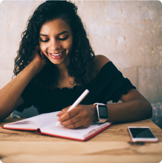 A woman writing in a notebook