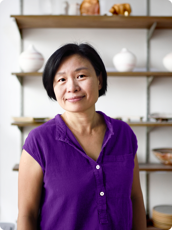 Elderly smiling woman in a purple blouse
