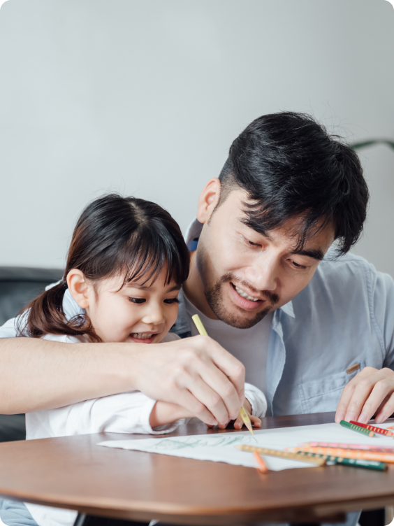 Father and daughter drawing at the desk