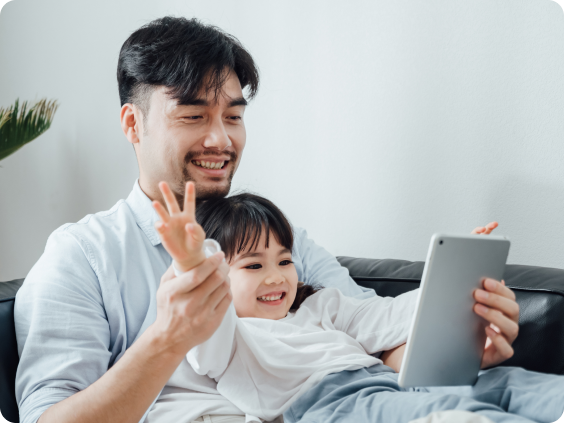 Father and son on sofa with tablet