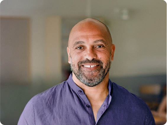 Smiling man in a purple T-shirt