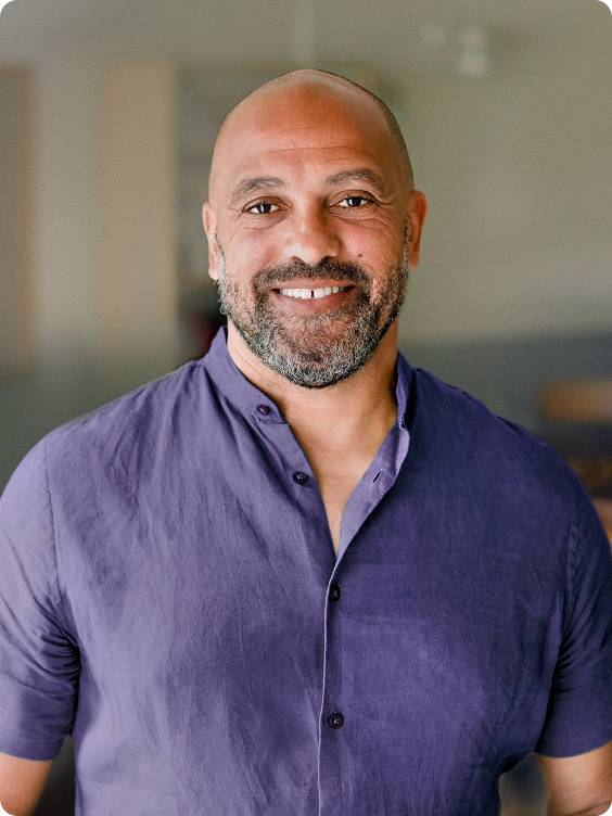 Smiling man in a purple T-shirt