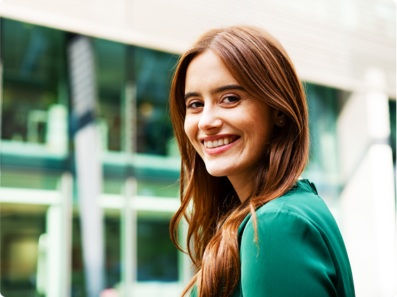 Young smiling brunette in a green blouse