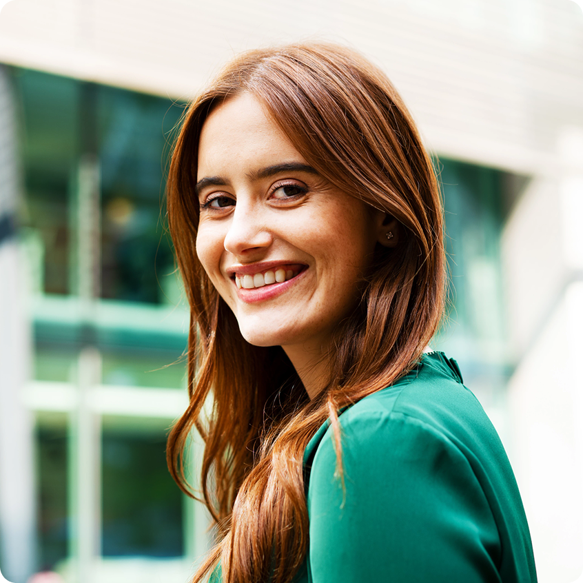 Young smiling brunette in a green blouse